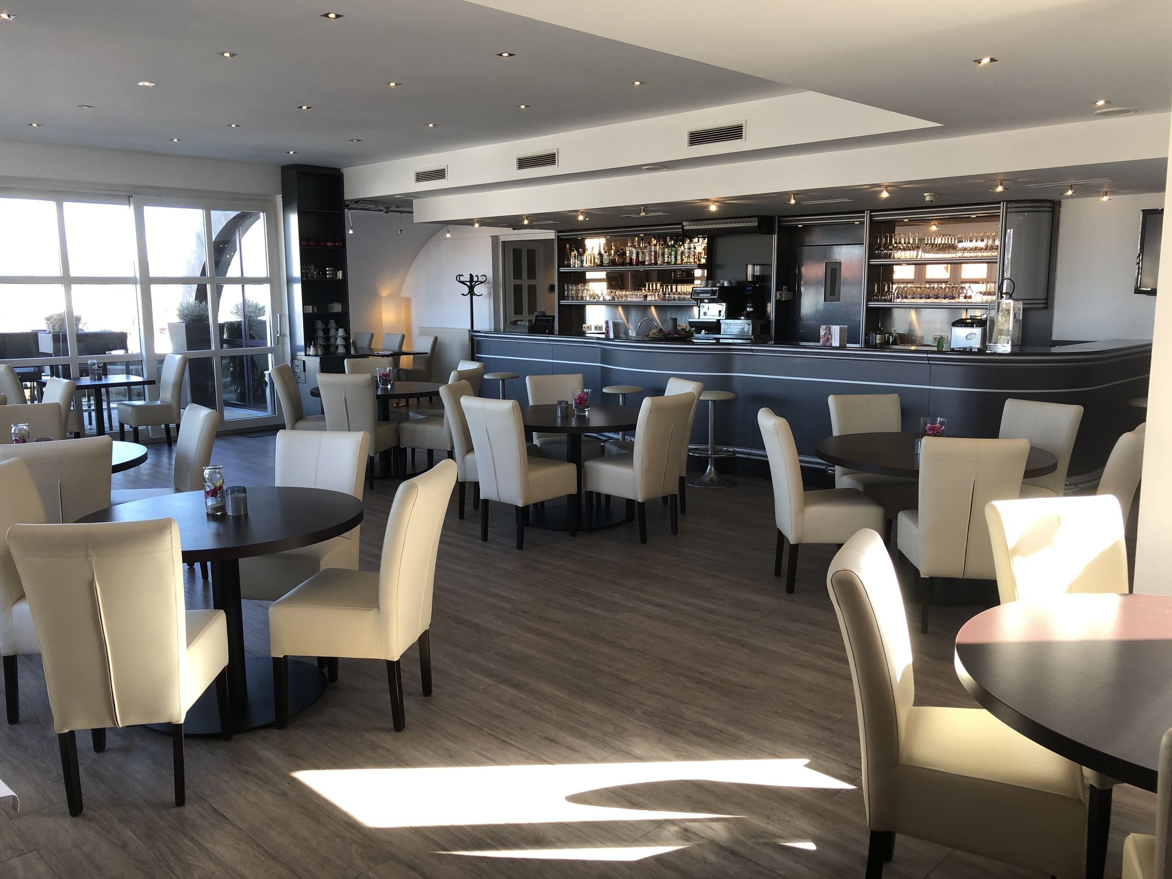 A modern bar area with seating and a bar counter.