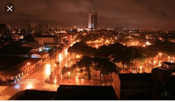 A nighttime cityscape with illuminated streets and buildings.