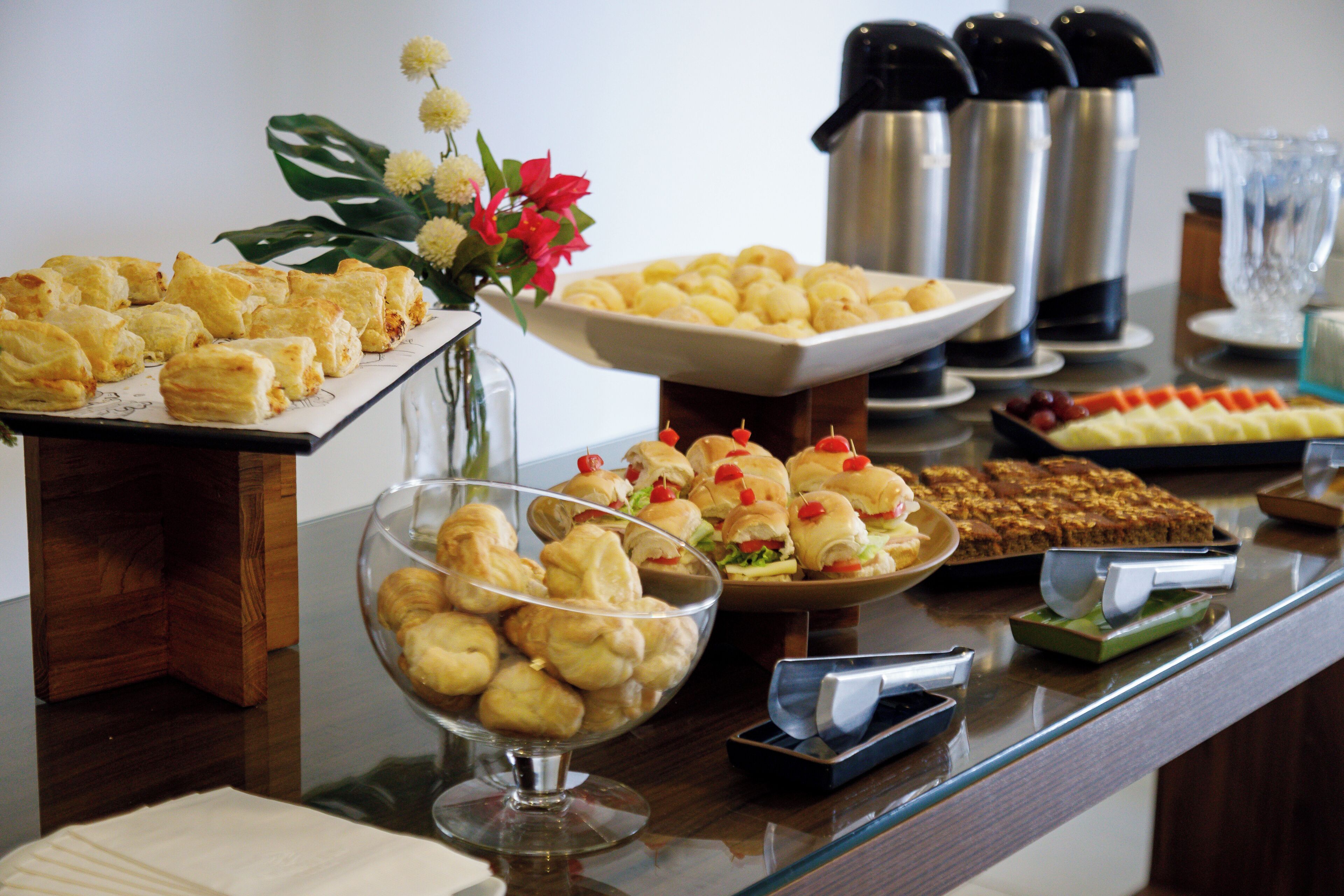 Un buffet proposant une variété de plats, notamment des pâtisseries et un assortiment de fruits.