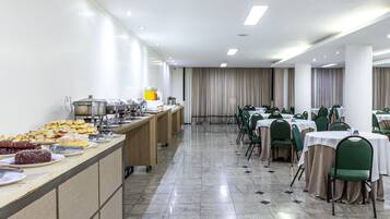 A buffet setup with various food items and a long counter.