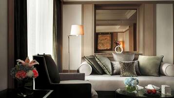 A modern living room with a sofa, a floor lamp, a vase with flowers, and a coffee table with a newspaper.