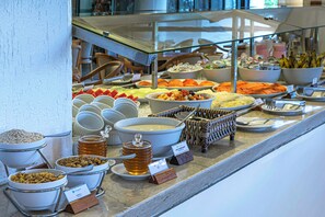 A buffet with various food items and condiments.