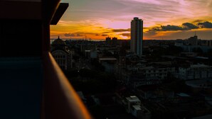 A cityscape at sunset with a prominent building in the center. - GoldMen Business Manaus - Taj Mahal (Manaus)