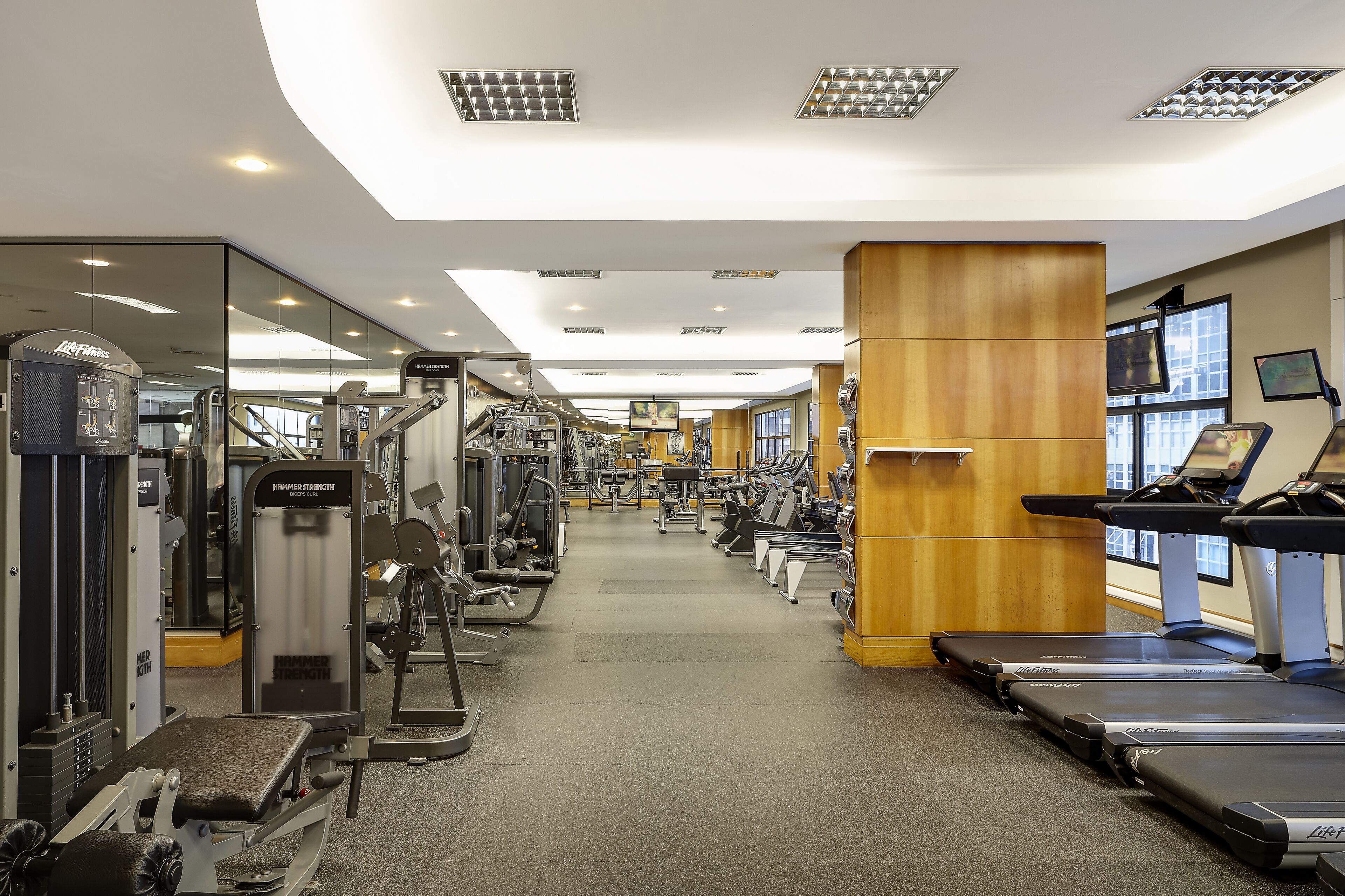 A gym with various exercise equipment, including treadmills and weight machines.