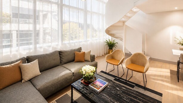 A modern living room with a sofa, two chairs, a coffee table, and a staircase. - 45 by Director (Santiago)