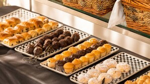 A buffet with various baked goods and pastries. - 45 by Director (Santiago)