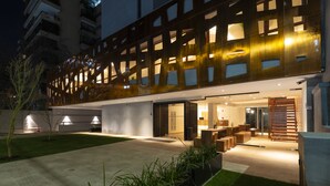A modern building with a geometric facade, a spacious entrance, and a well-lit interior. - 45 by Director (Santiago)