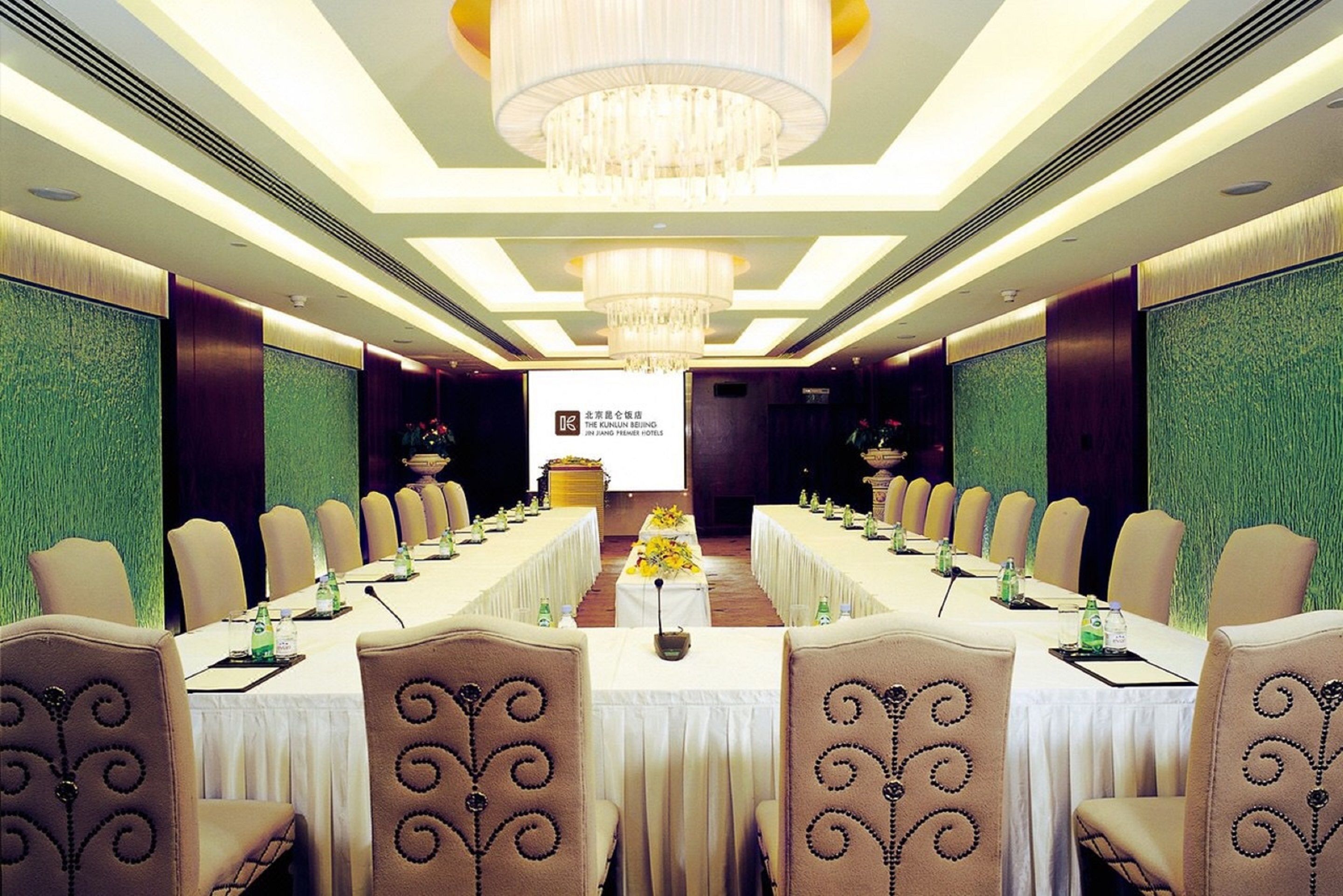 A conference room with a long table, chairs, and a chandelier.