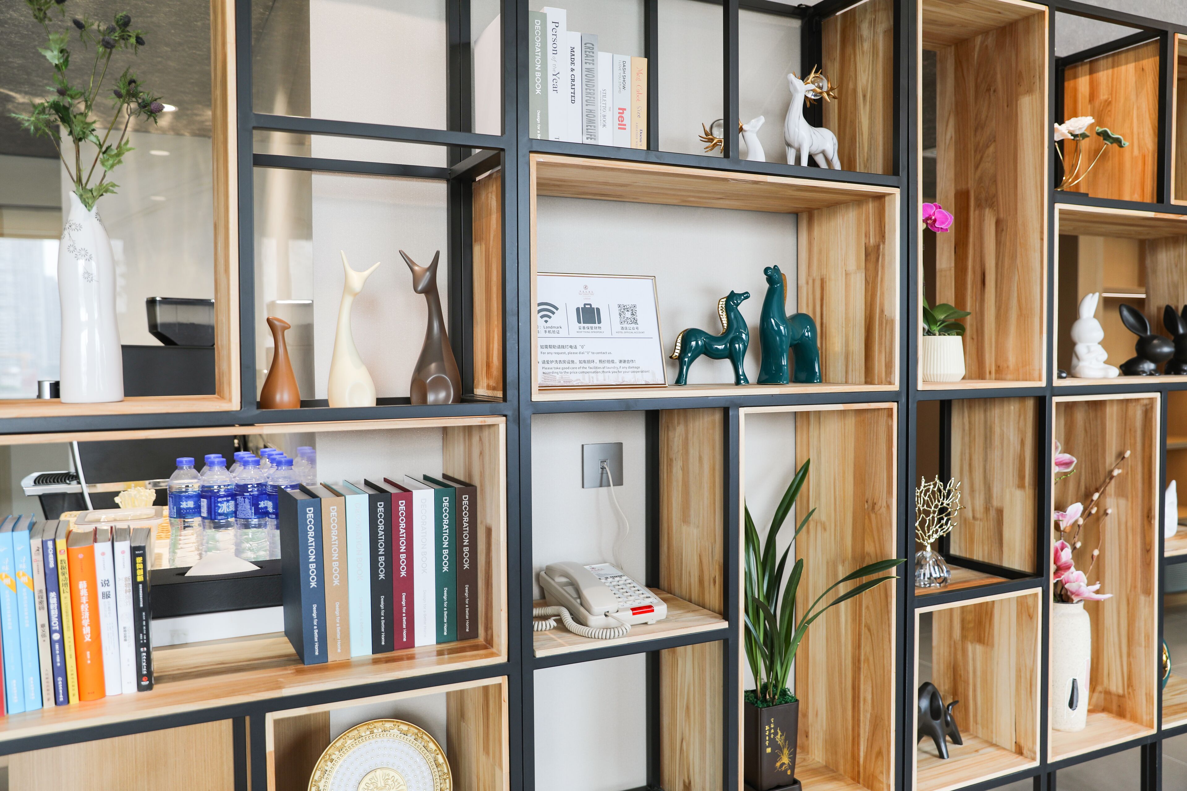 A multi-tiered shelving unit with various decorative items and books.
