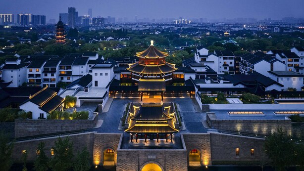 A traditional multi-tiered pagoda with a courtyard, surrounded by modern buildings. - Pan Pacific Suzhou (Suzhou)