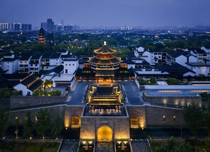 A traditional multi-tiered pagoda with a courtyard, surrounded by modern buildings. - Pan Pacific Suzhou (Suzhou)