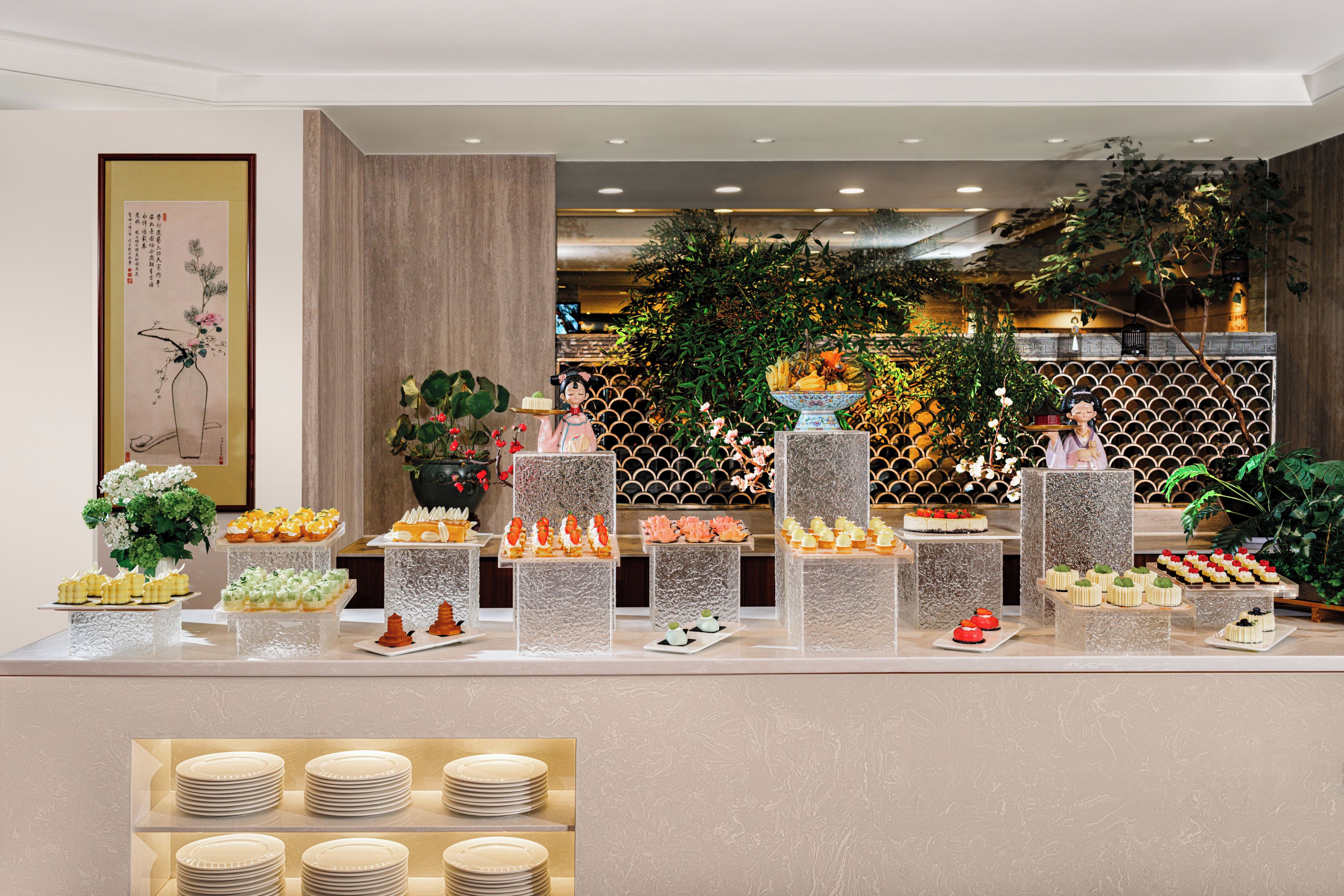 A buffet with various food items and a decorative figure.