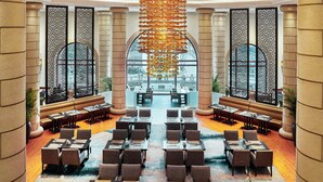 A spacious lobby with a central seating area, high ceilings, and large windows offering a view of the outdoors. - Pan Pacific Suzhou (Suzhou)