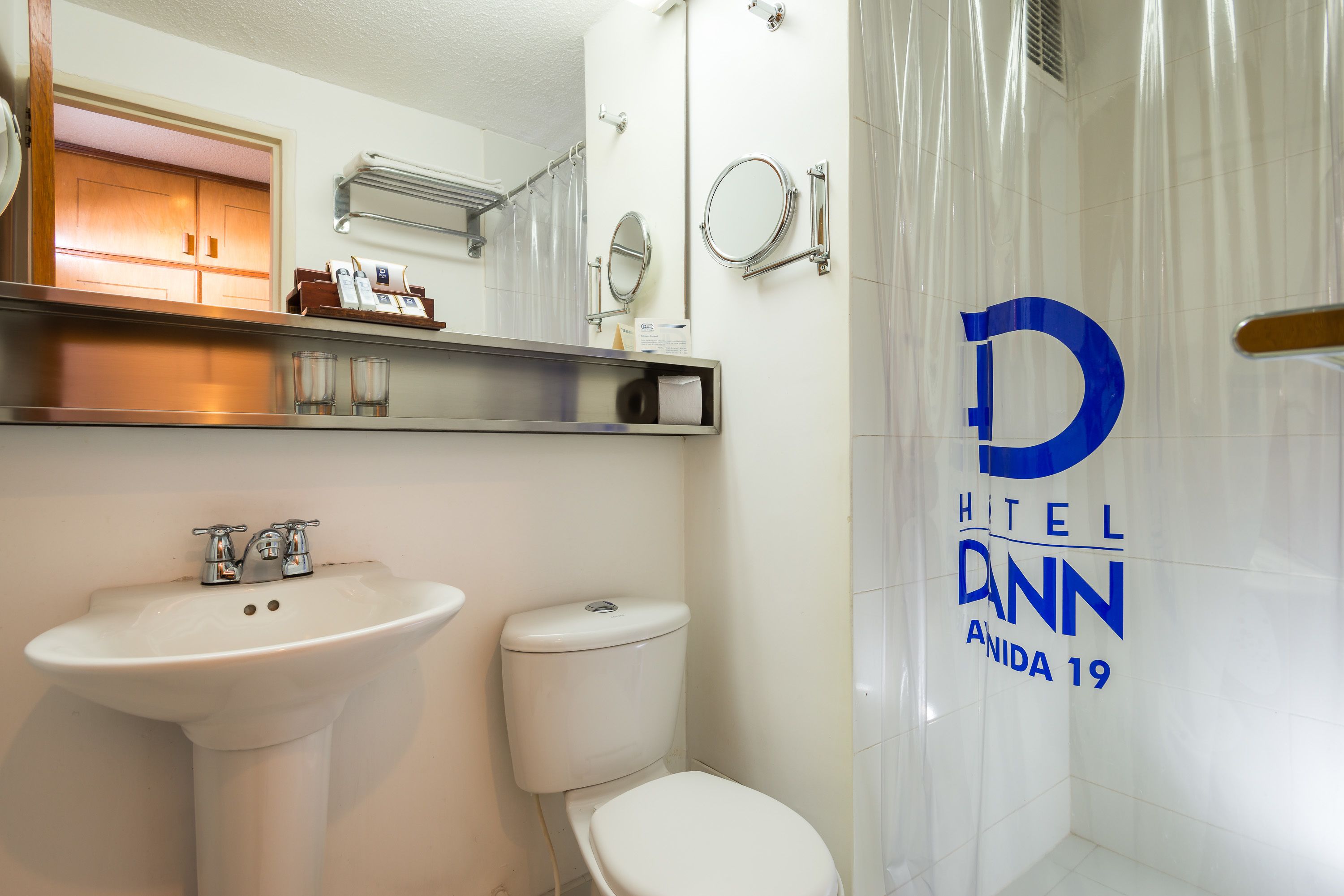 A modern bathroom with a sink, toilet, and a shower enclosure.