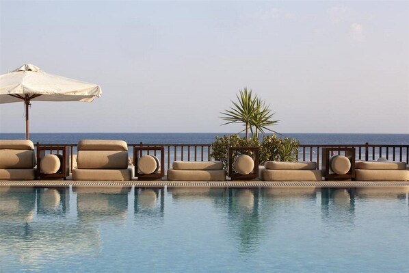 Piscine extérieure, parasols de plage, chaises longues