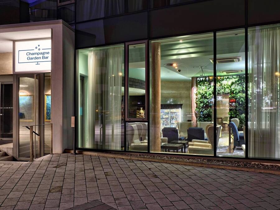 Un edificio moderno con un cartel que dice 'Champagne Garden Bar'.