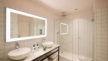 Un baño moderno con un espejo grande, dos lavamanos, una ducha y cabina de ducha con paredes de vidrio.