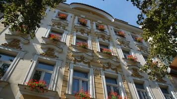 A multi-story building with ornate architectural details, including decorative moldings and window frames.