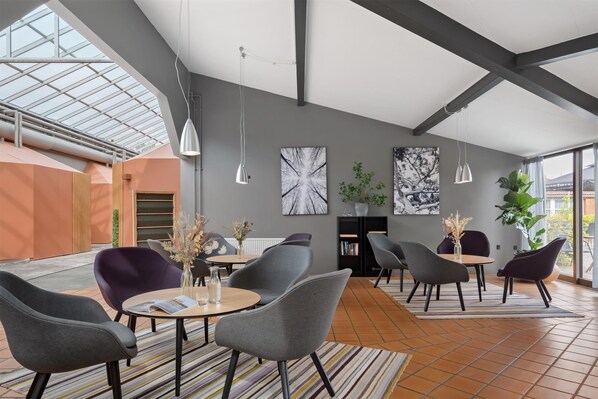 A spacious indoor area with modern furniture, large windows, and a high ceiling. - Best Western Hotel Hillerod (Hillerod)