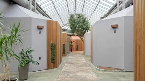 A corridor with a tiled floor, potted plants, and wooden paneling. - Best Western Hotel Hillerod (Hillerod)