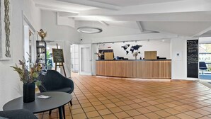 A spacious lobby with a reception desk, a world map on the wall, and a tiled floor. - Best Western Hotel Hillerod (Hillerod)
