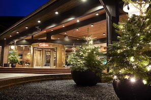 A building with a 'Casino' sign, a Christmas tree, and a potted plant in front.