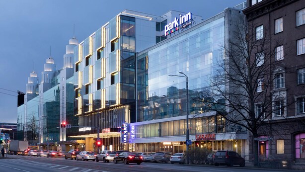 A modern hotel with a glass facade, a prominent 'Park Inn' sign, and a 'Caravan' restaurant. - Park Inn by Radisson Central Tallinn (Tallinn)