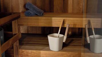 A wooden bench with a rolled towel and two white buckets with wooden handles.