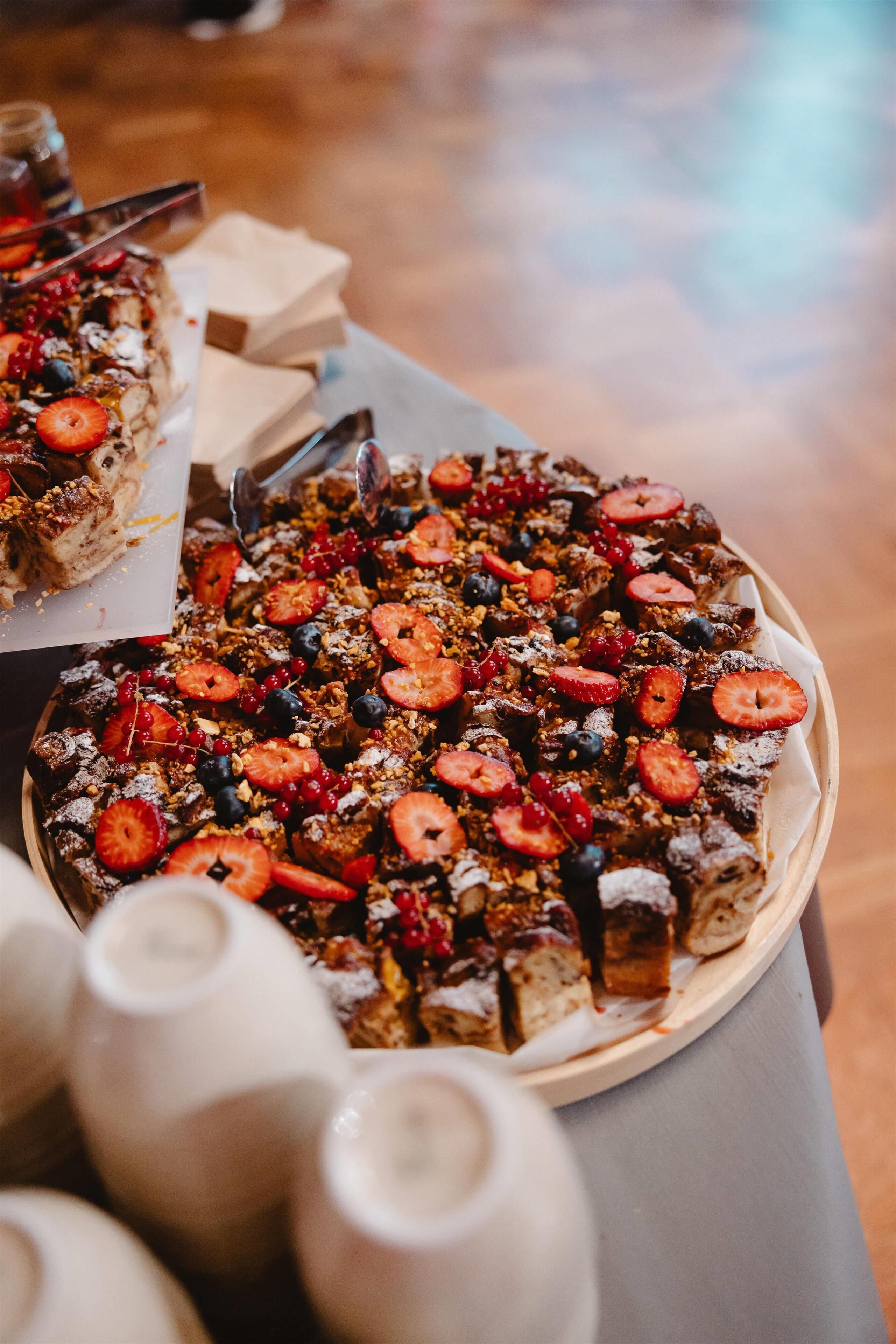 A dessert platter with various fruits and toppings.
