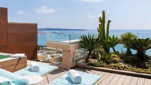 A rooftop terrace with a pool, sun loungers, and a view of the sea. - Mondrian Cannes (Cannes)