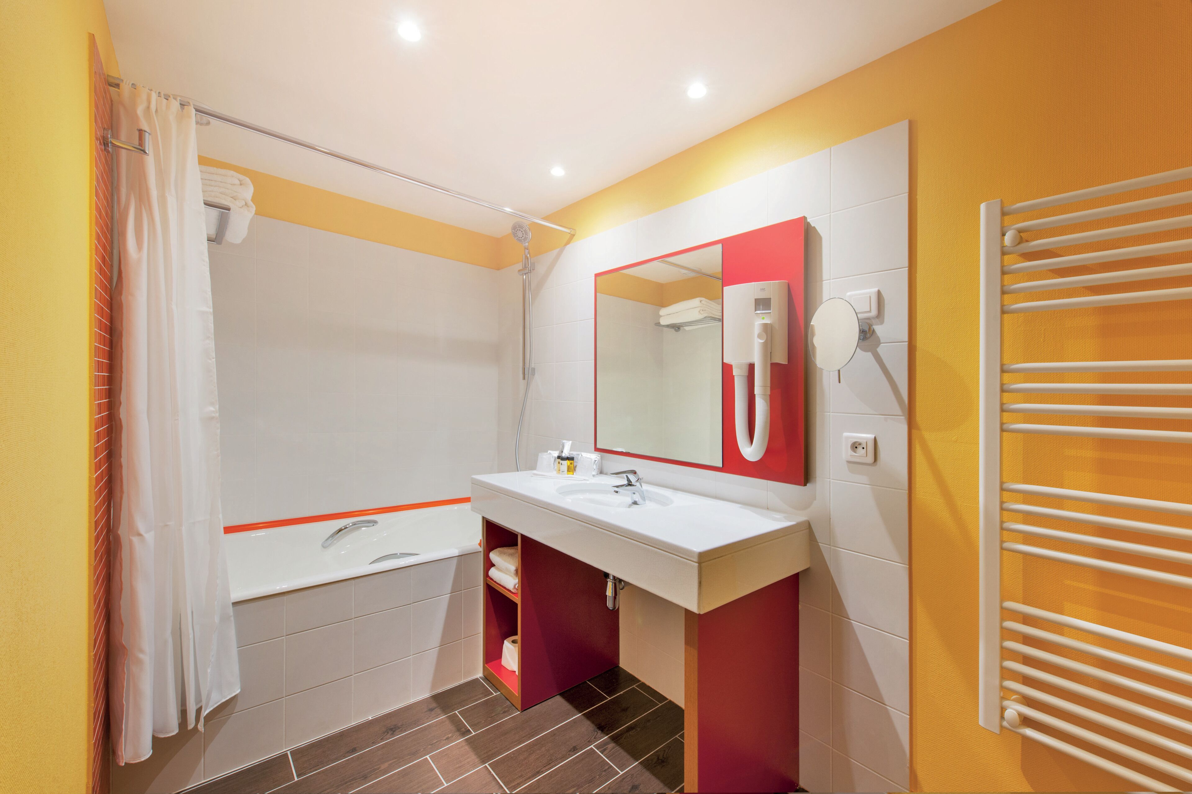 A bathroom with a shower, a sink, a mirror, and a towel rack.