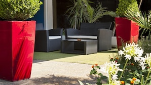 A hotel named 'HOTEL Galaxie' with outdoor seating and potted plants. - The Originals City, Hôtel Galaxie, Nice Aéroport (Saint-Laurent-du-Var)