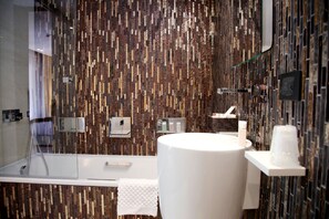 Deep-soaking bathtub, rainfall showerhead, designer toiletries