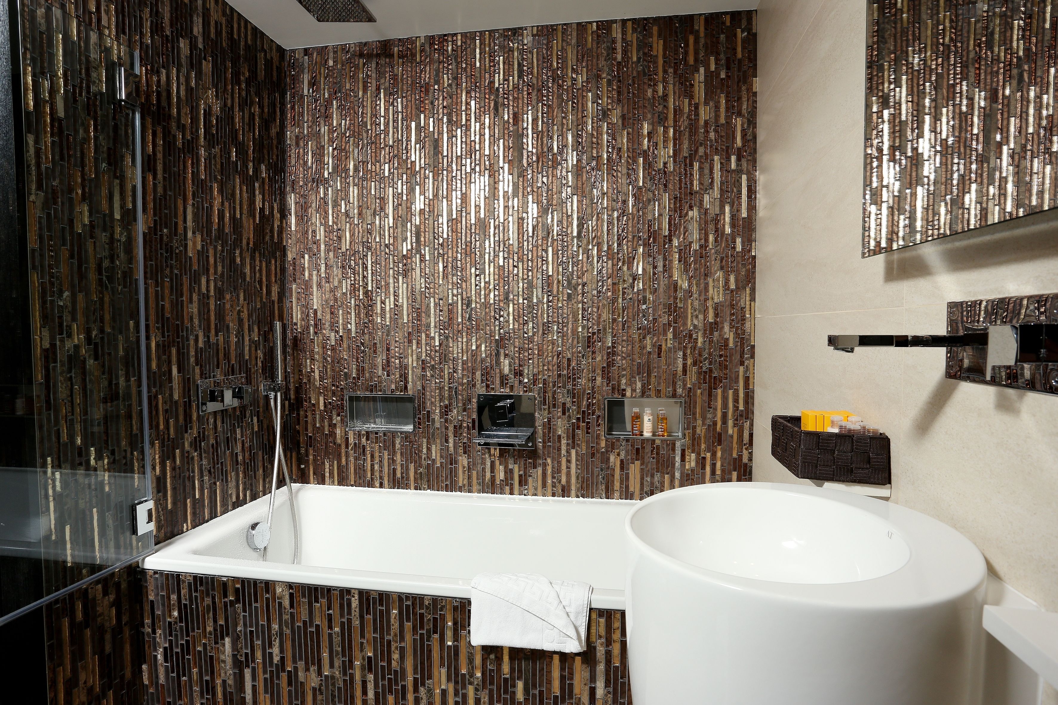 deep-soaking bathtub, rainfall showerhead, designer toiletries