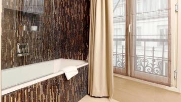 Deep-soaking bathtub, rainfall showerhead, designer toiletries
