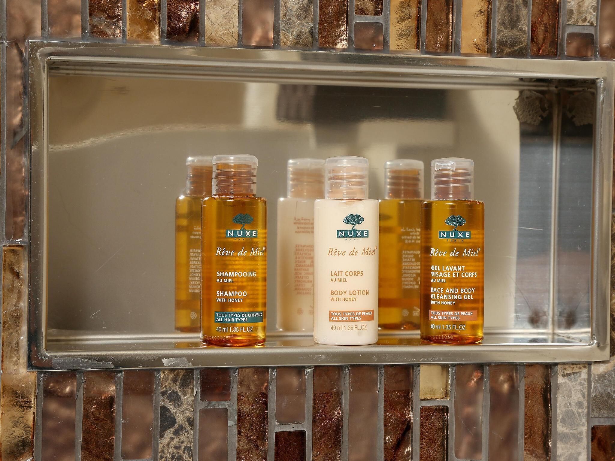 deep-soaking bathtub, rainfall showerhead, designer toiletries