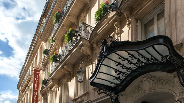 A historic building with ornate balconies, a prominent 'HOTEL MAYFAIR' sign, and classic architectural details. - Hotel Mayfair (Paris)
