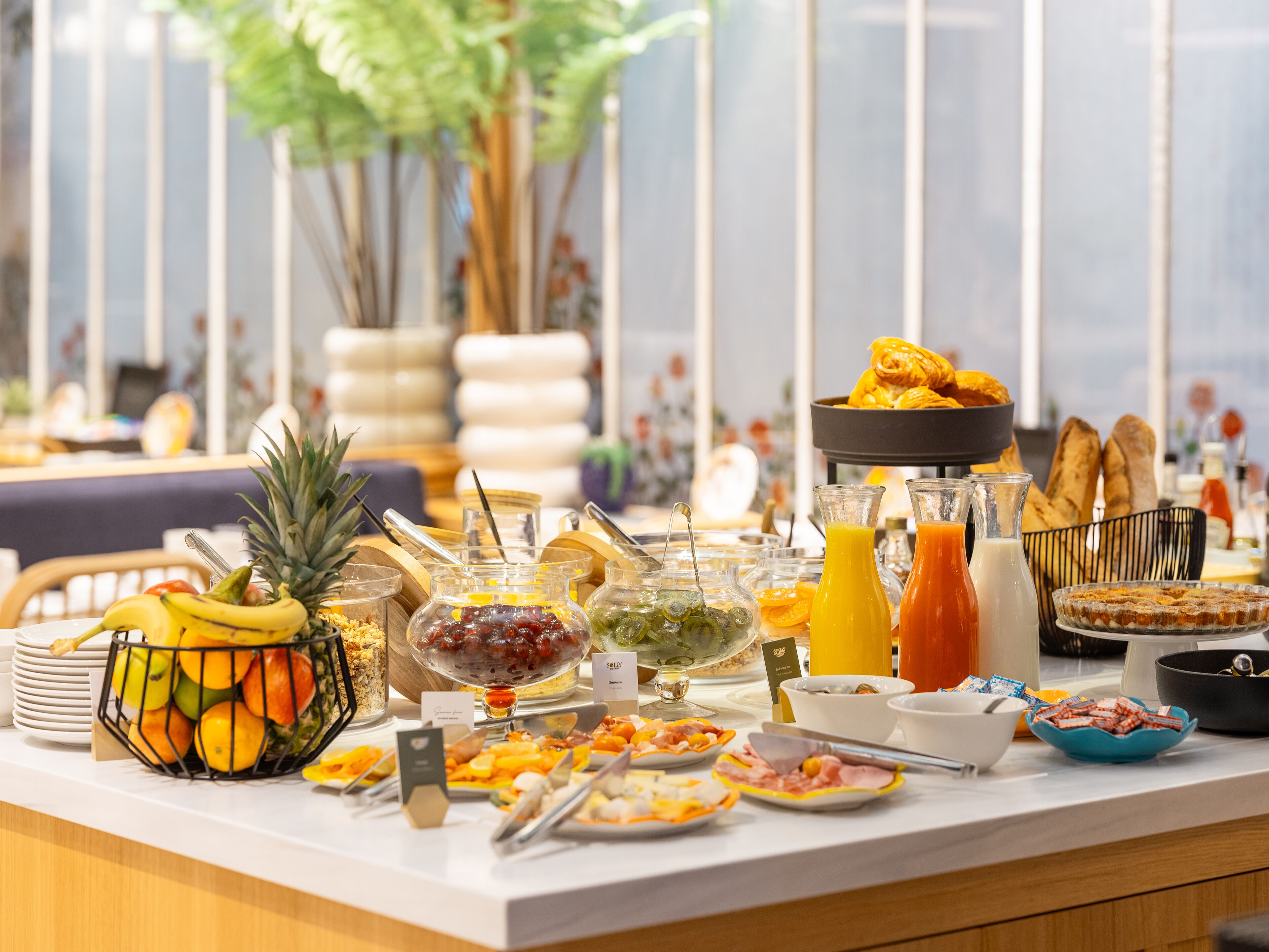 A buffet with various food items and beverages.