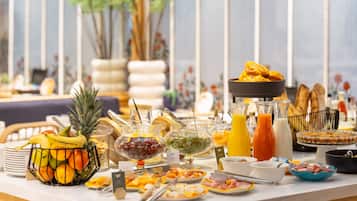 A buffet with various food items and beverages.