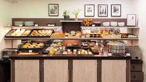 A buffet with various food items, including pastries, fruits, and condiments. - Hotel Apolonia Paris Mouffetard, Sure Hotel Collection by BW (Paris)