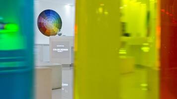 A reception area with a spherical decorative object and a sign that reads "RECEPTION COLOR DESIGN HOTEL."