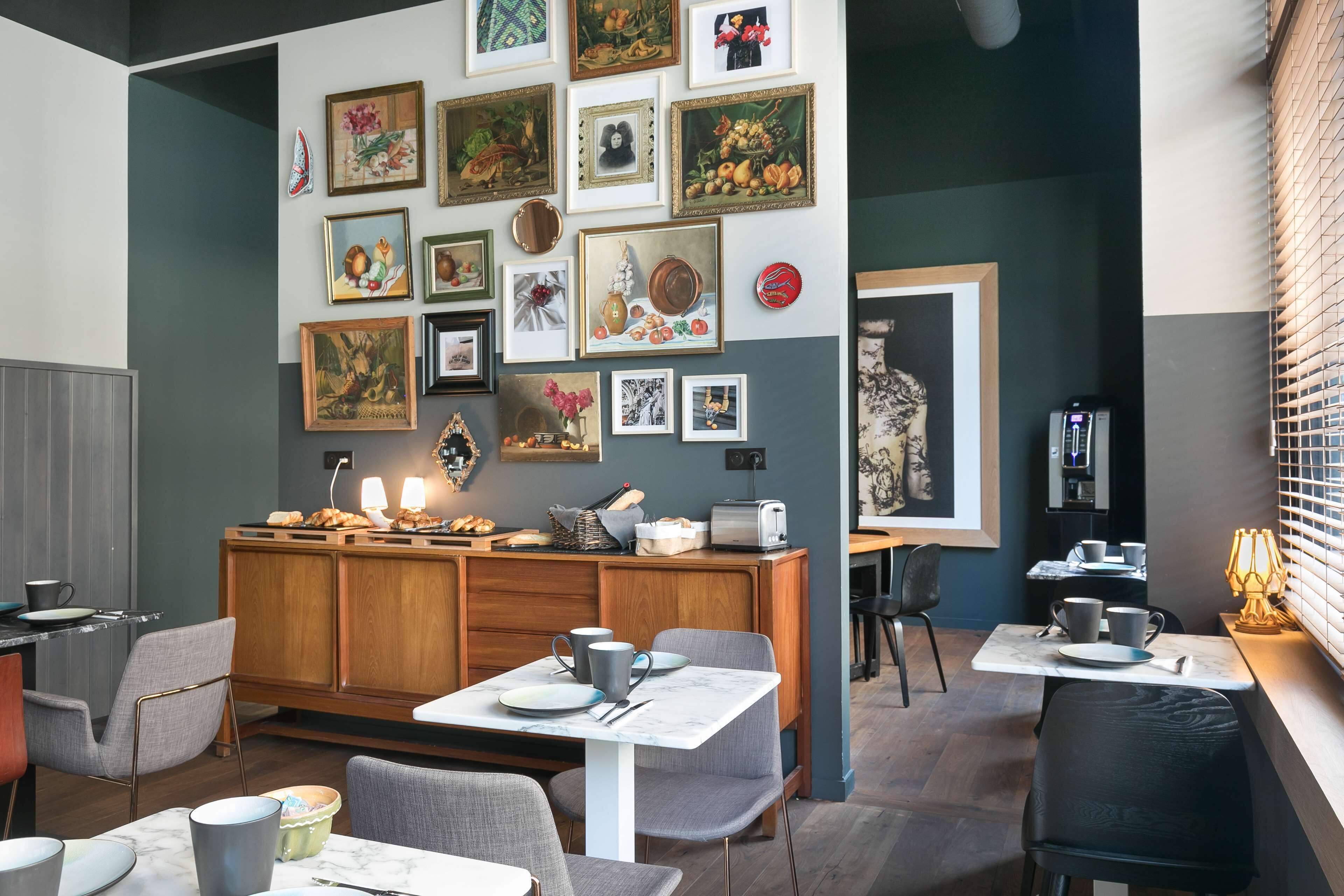 A cozy dining area with a wooden cabinet, marble tables, and chairs.