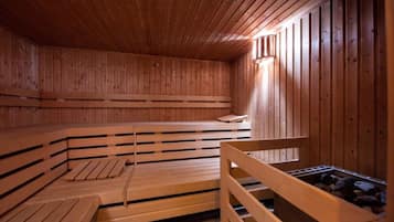 A sauna with wooden benches and a bench with a backrest.