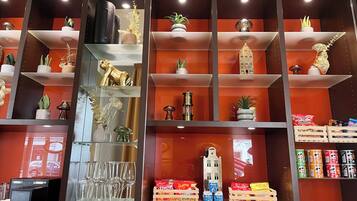 A display of various items including glassware, decorative objects, and packaged snacks.