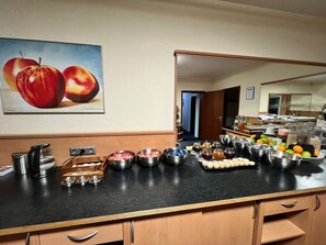 A kitchen counter with various food items and a coffee maker. - acora Bonn Living the City (Bonn)