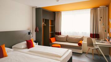 Hypo-allergenic bedding, desk, laptop workspace, blackout drapes
