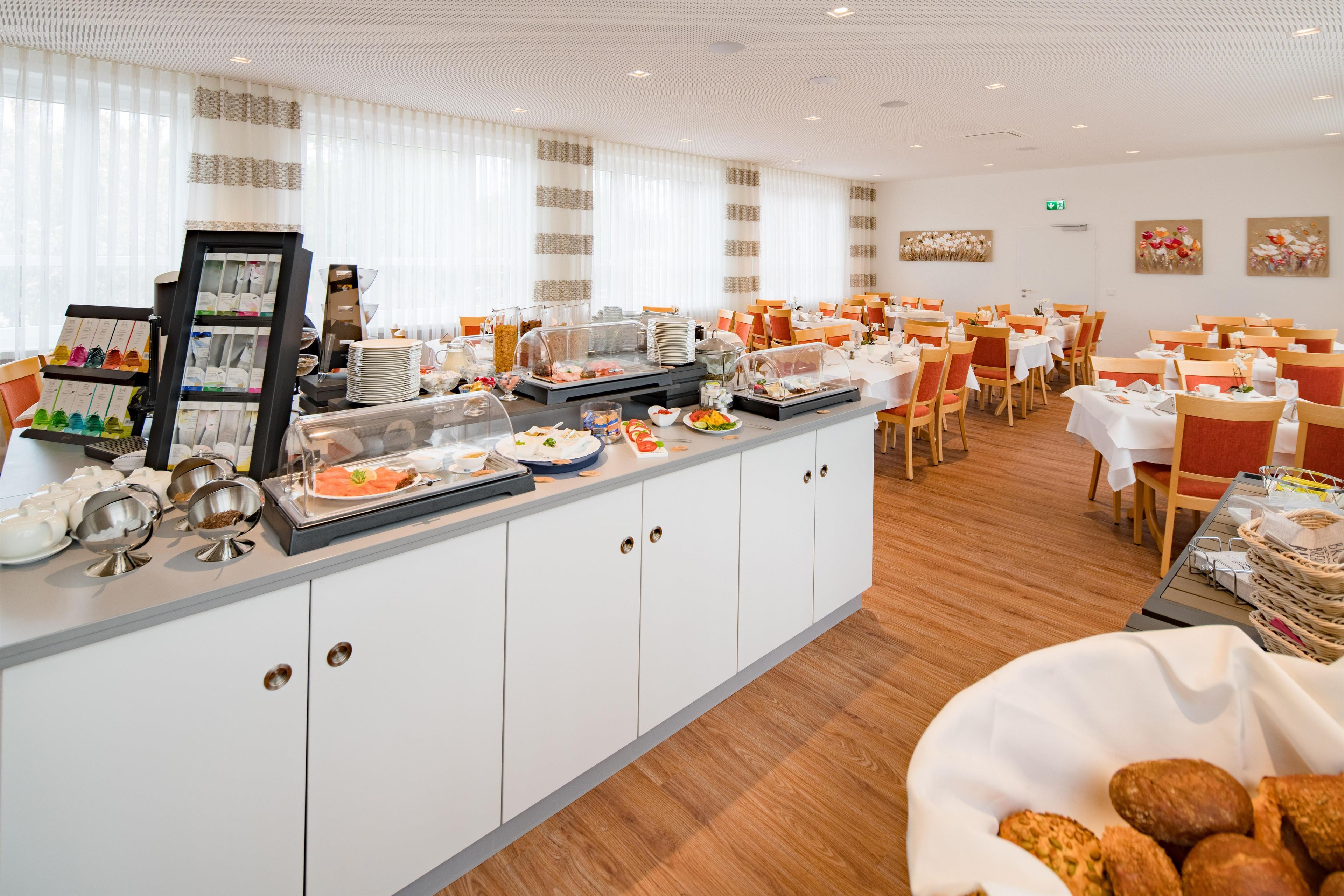 A buffet area with a variety of food items and a selection of beverages.