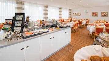 A buffet area with a variety of food items and a selection of beverages.