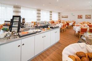 A buffet area with a variety of food items and a selection of beverages.