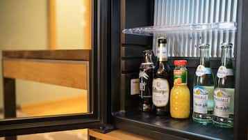 A minibar with various bottles of alcohol, including a bottle of Citrauselle and a bottle of orange juice.
